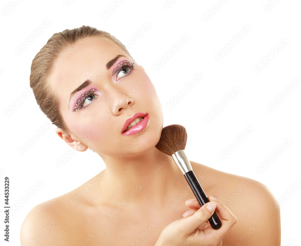 A beautiful young woman doing make-up A beautiful young woman doing make-up