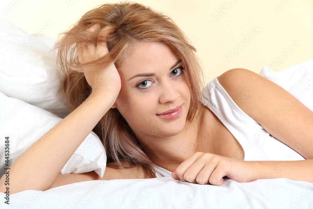 young beautiful woman lying on bed in bedroom young beautiful woman lying on bed in bedroom