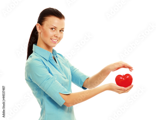 A woman holding a heart symbol, isolated onw hite photo