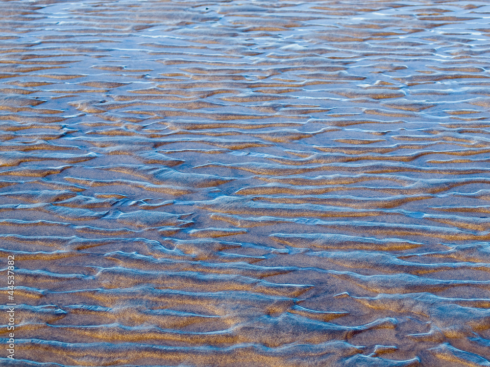 Fototapeta premium Ocean Ripples and Sand in Shallow Water on a Beach