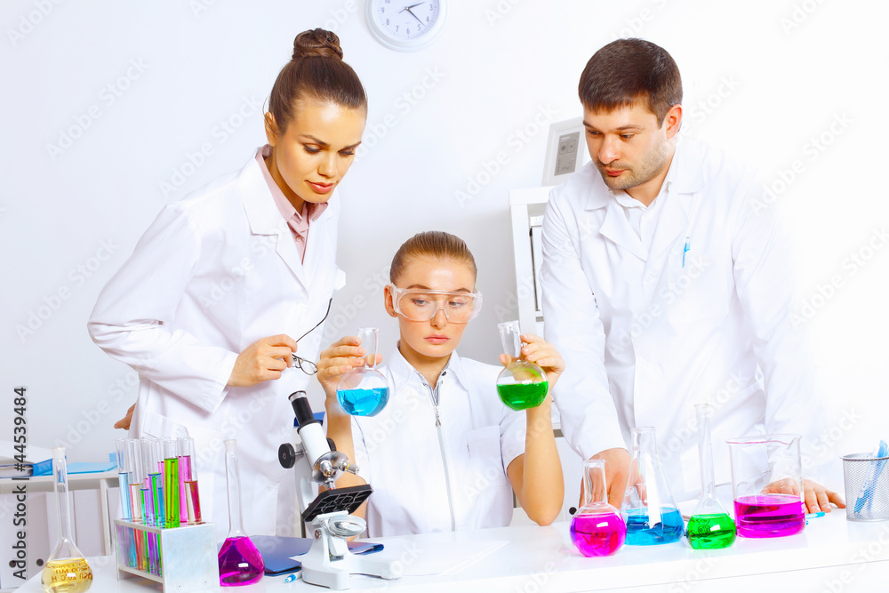 Team of scientists working in laboratory Team of scientists working in laboratory