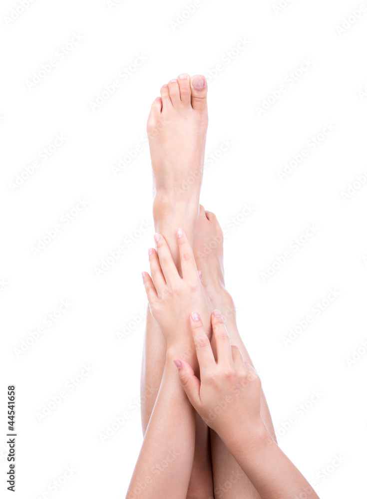 Beautiful woman crossed legs and hands isolated over white backg