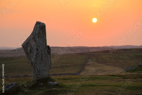 Isolated stone and sunset in Outer Hebrideans photo