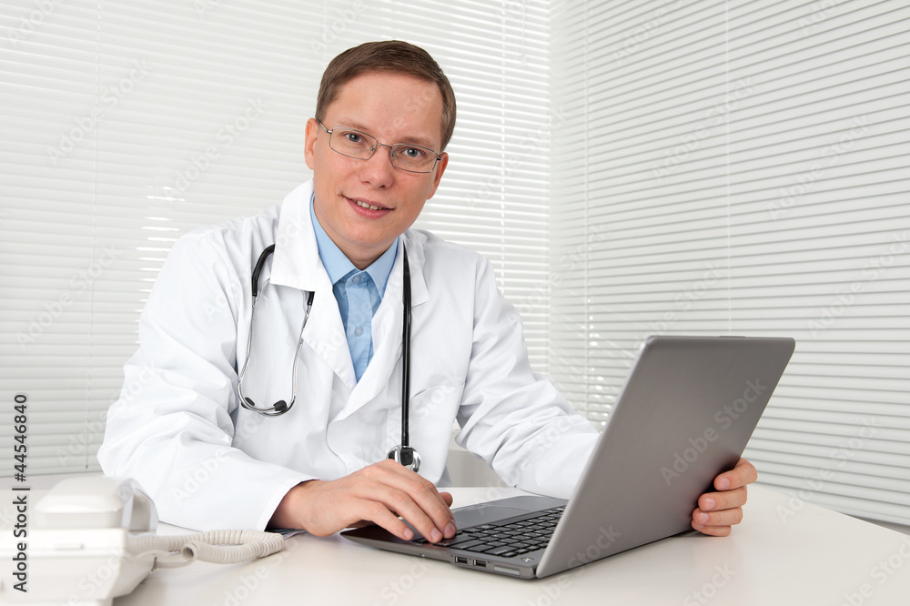 doctor in white coat with laptop computer doctor in white coat with laptop computer