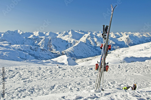 Skis plantés dans la neige, vue sur les Alpes photo