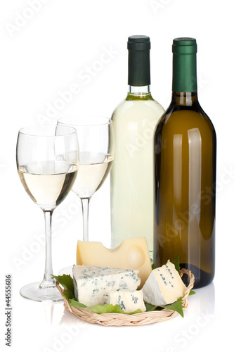 White wine bottles, two glasses and cheese