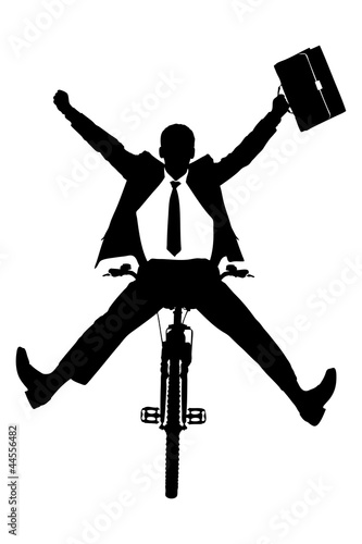 A silhouette of a happy businessman on a bicycle