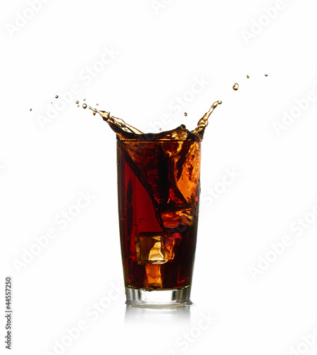 Ice cube droped in cola glass
