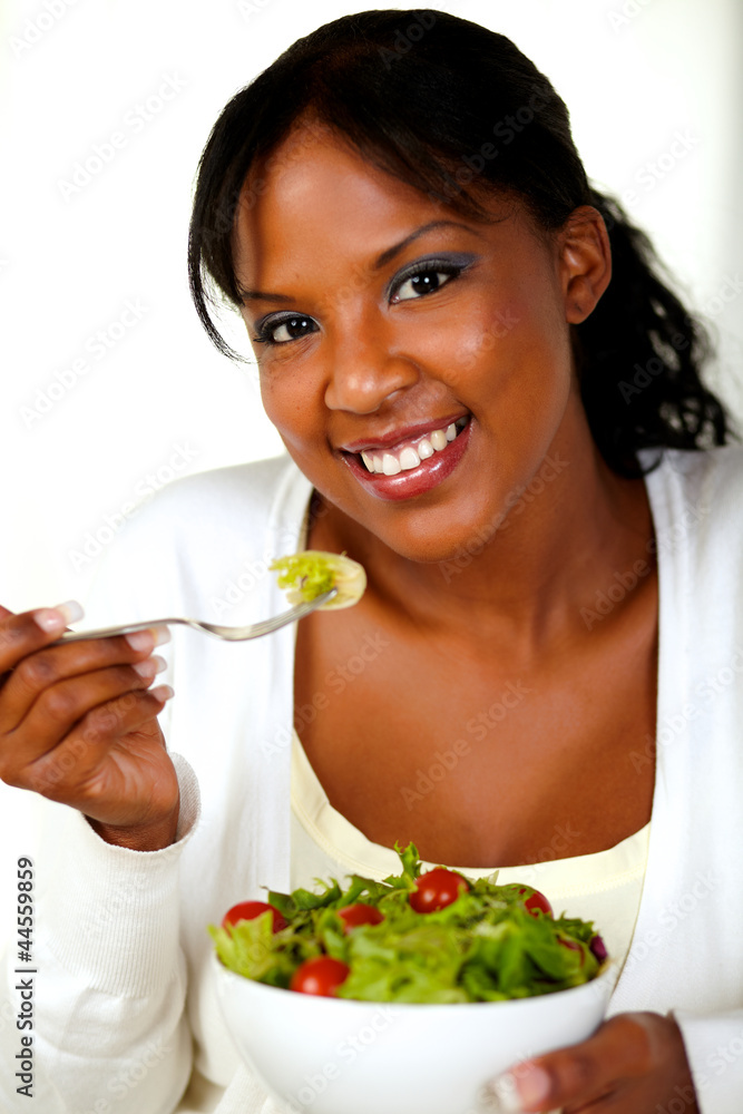 Gorgeous young woman eating vegetable salad Gorgeous young woman eating vegetable salad