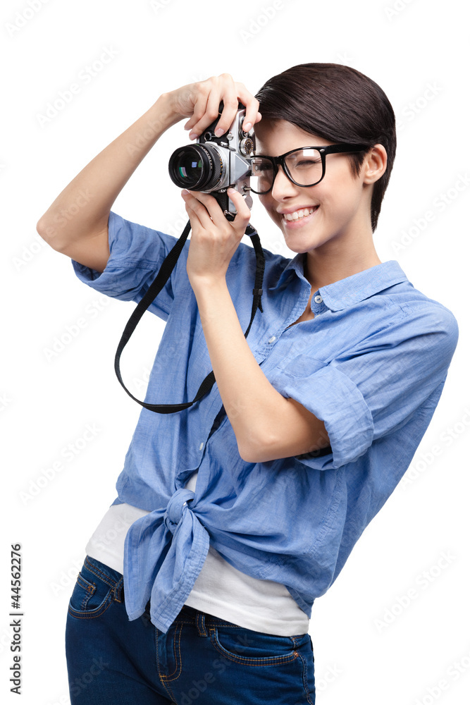 Woman in spectacles makes photos with retro photographic camera Woman in spectacles makes photos with retro photographic camera
