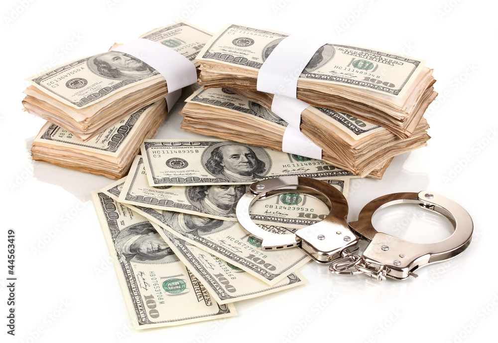Handcuffs and packs of dollars isolated on white Handcuffs and packs of dollars isolated on white