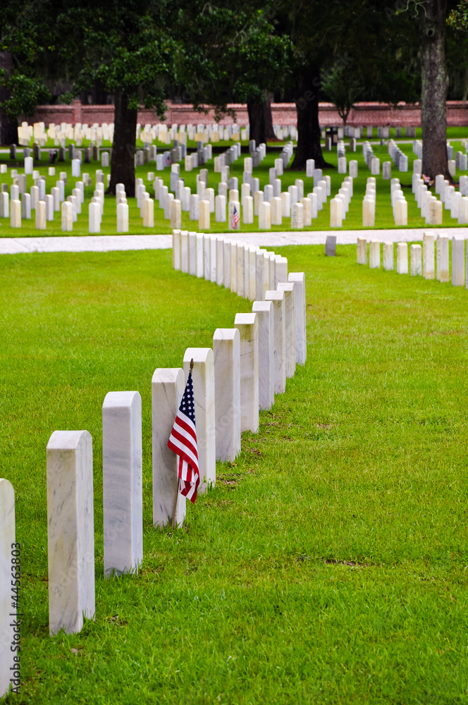 row of tombstones with american flag