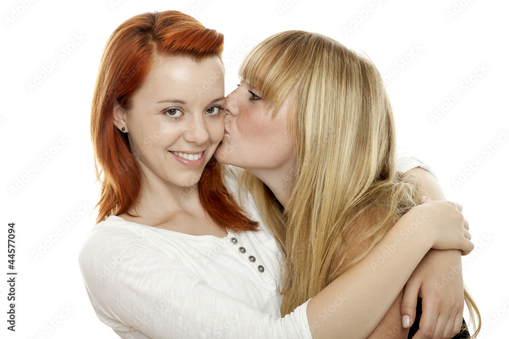 young beautiful red and blond haired girls kissing cheek young beautiful red and blond haired girls kissing cheek