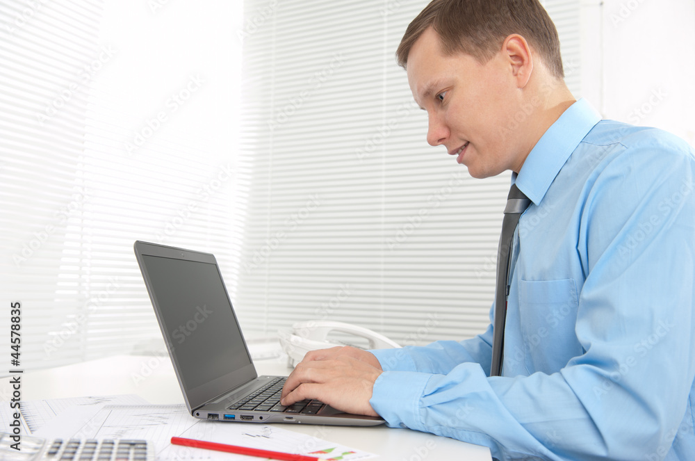 Portrait of handsome business man working with laptop Portrait of handsome business man working with laptop
