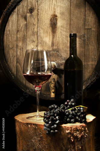 Still life with red glass of wine in the cellar