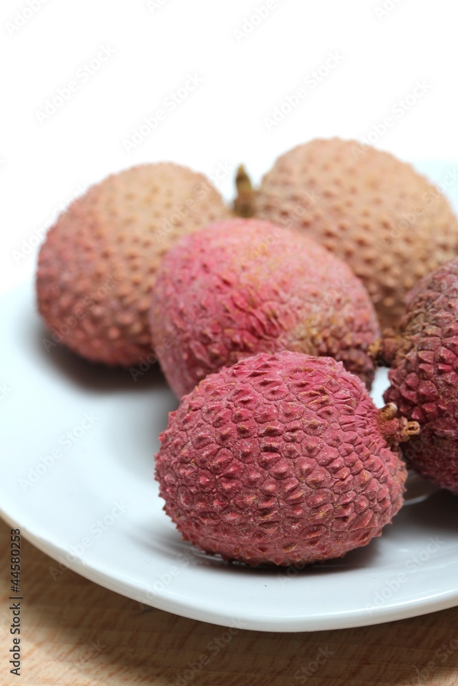 fresh lychees on a porcelain plate fresh lychees on a porcelain plate