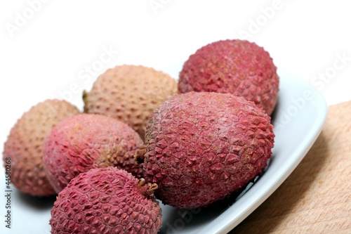 fresh lychees on a porcelain plate photo