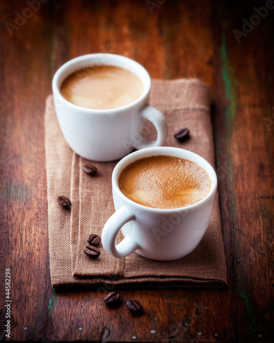 Bilde på lerret Two cups of espresso on brown napkin