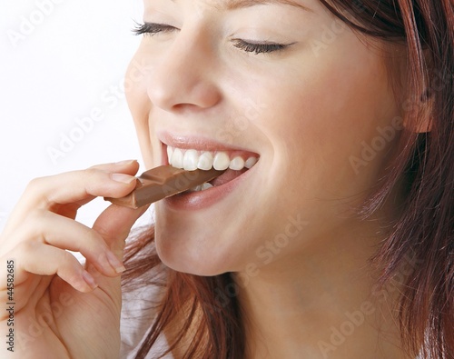 young beautiful woman with a bar of chocolate photo