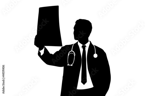 A silhouette of a medical doctor examining CT scan