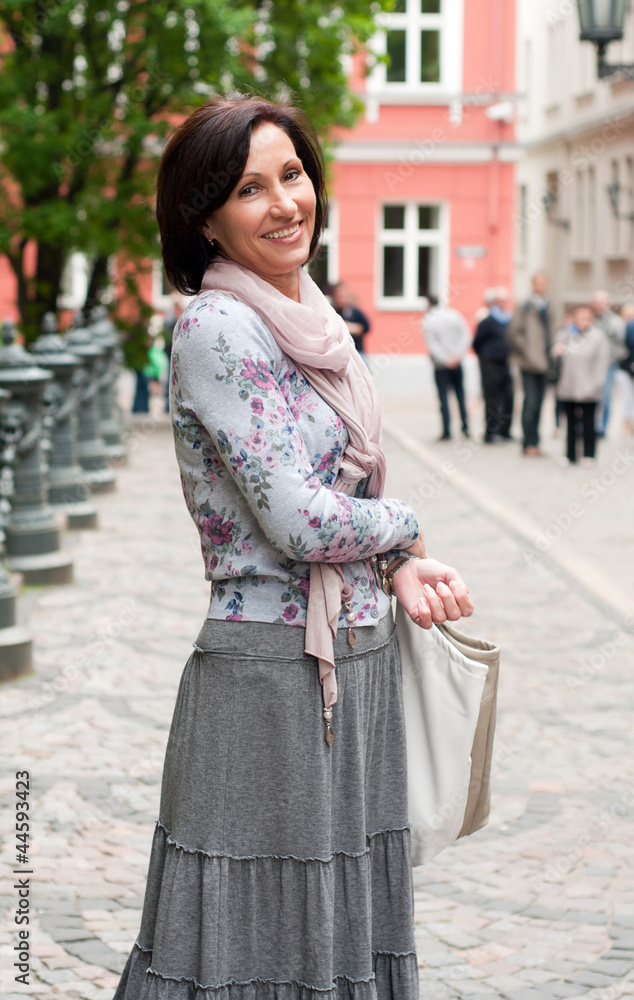 Portrait of smiling brunette woman in town