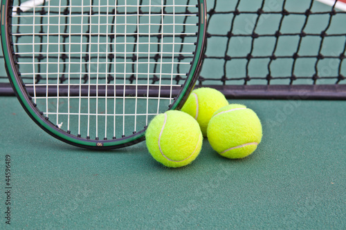 Tennis court with ball and racket