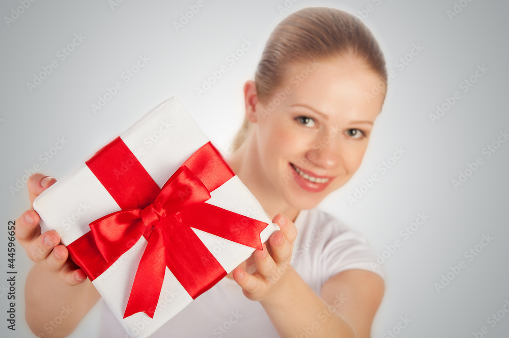 beautiful young woman with a Christmas gift with red ribbon in t beautiful young woman with a Christmas gift with red ribbon in t