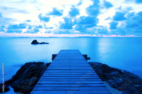 Wooden pier at the beach in the morning light photo