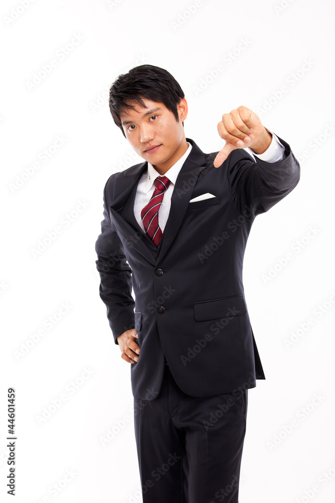 Young disappointed business man giving you the thumbs down sign Young disappointed business man giving you the thumbs down sign