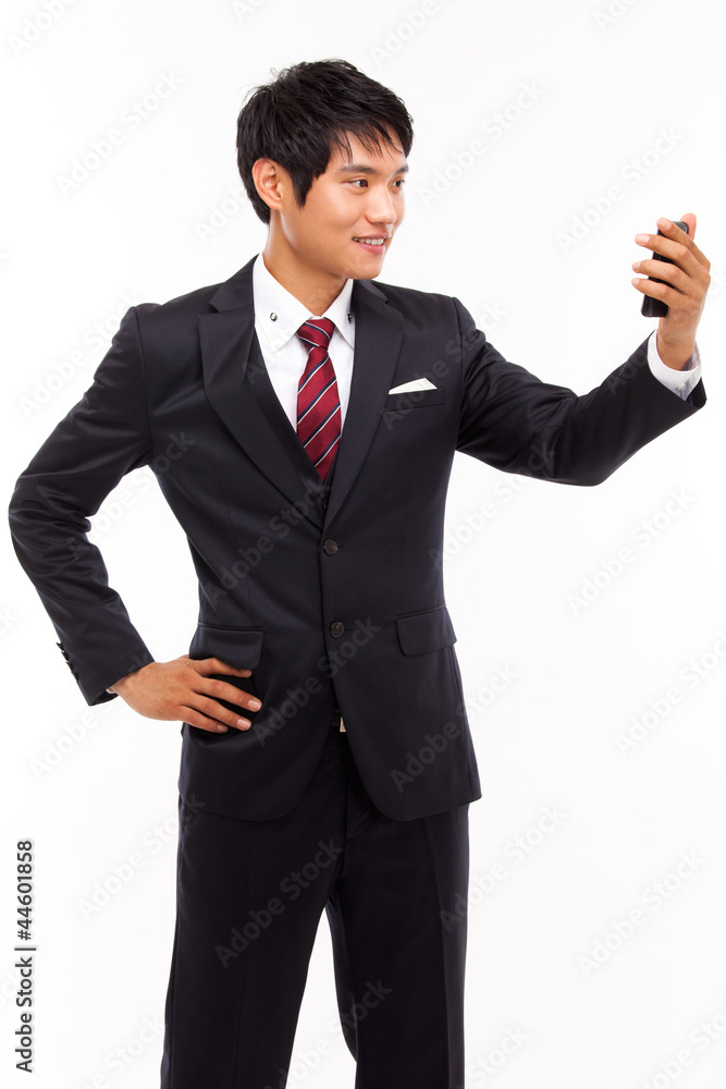 Asian business man with cellphone isolated on white background. Asian business man with cellphone isolated on white background.