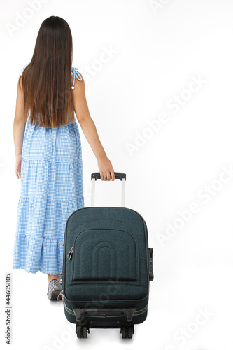 a little girl pulling a suitcase and goes