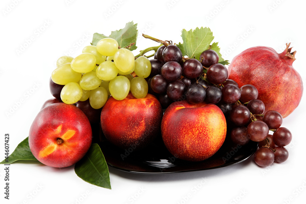 Fruits nectarine and a bunch of grapes isolated against white ba Fruits nectarine and a bunch of grapes isolated against white ba