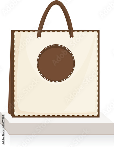 beige, brown shopping bag on stand