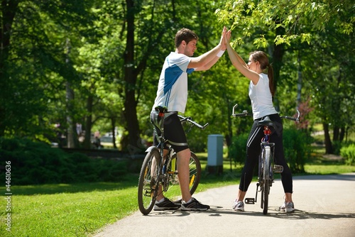 Happy couple ridine bicycle outdoors