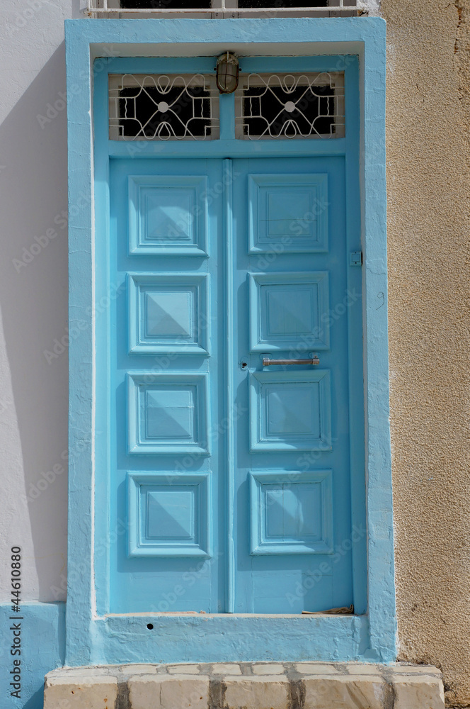 Fototapeta premium Blue door in the traditional tunisian architecture