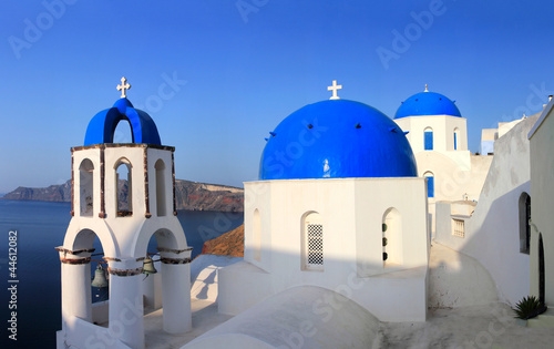 Greek orthodox church with Ferry boat in Santorini