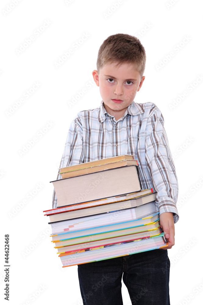 The schoolchild with a huge pile of heavy books in hands. The schoolchild with a huge pile of heavy books in hands.