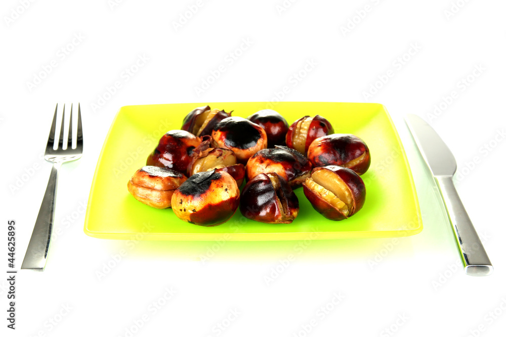 roasted chestnuts in the green plate with fork and knife roasted chestnuts in the green plate with fork and knife