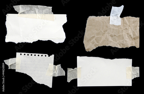 Four torn papers taped to black
