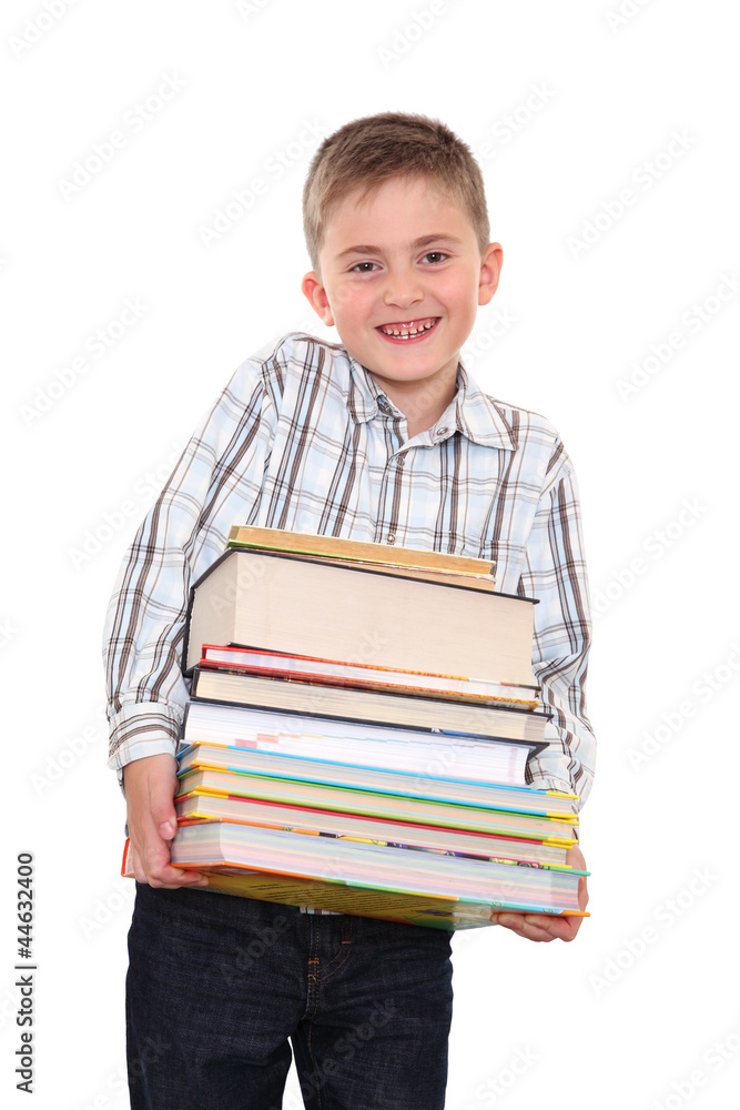 The schoolchild with a huge pile of heavy books in hands. The schoolchild with a huge pile of heavy books in hands.
