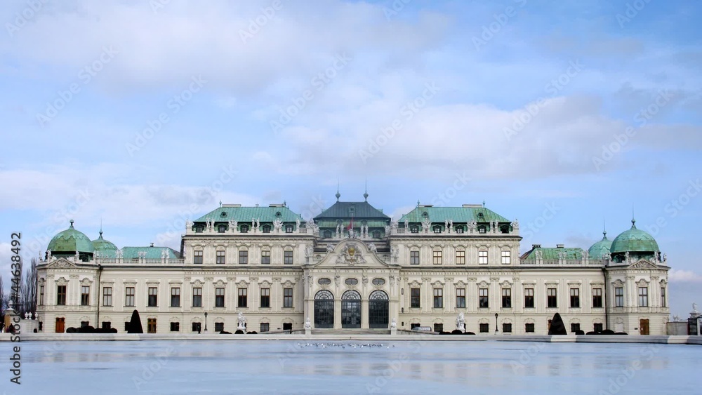 Tourists visit castle Belvedere which stands before pond Tourists visit castle Belvedere which stands before pond