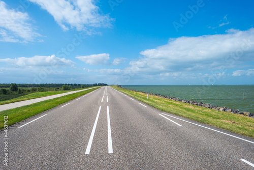 Wallpaper Mural Road on a dike along a lake Torontodigital.ca