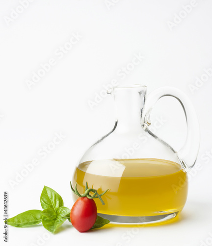 bottle with olive oil tomato cherry and basil