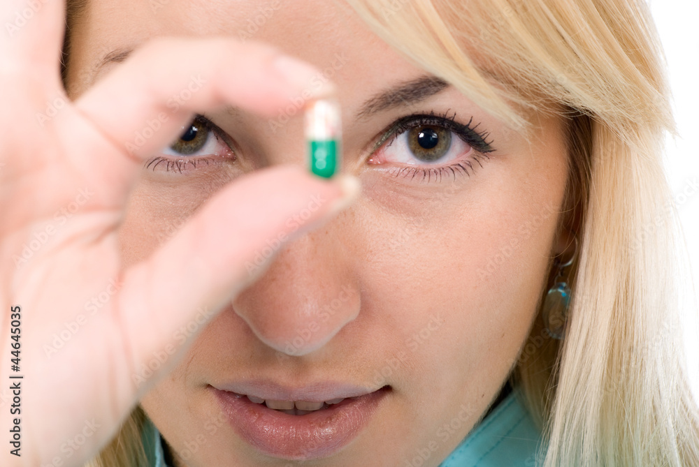 Female-doctor holds capsule - offering it to the patient Female-doctor holds capsule - offering it to the patient