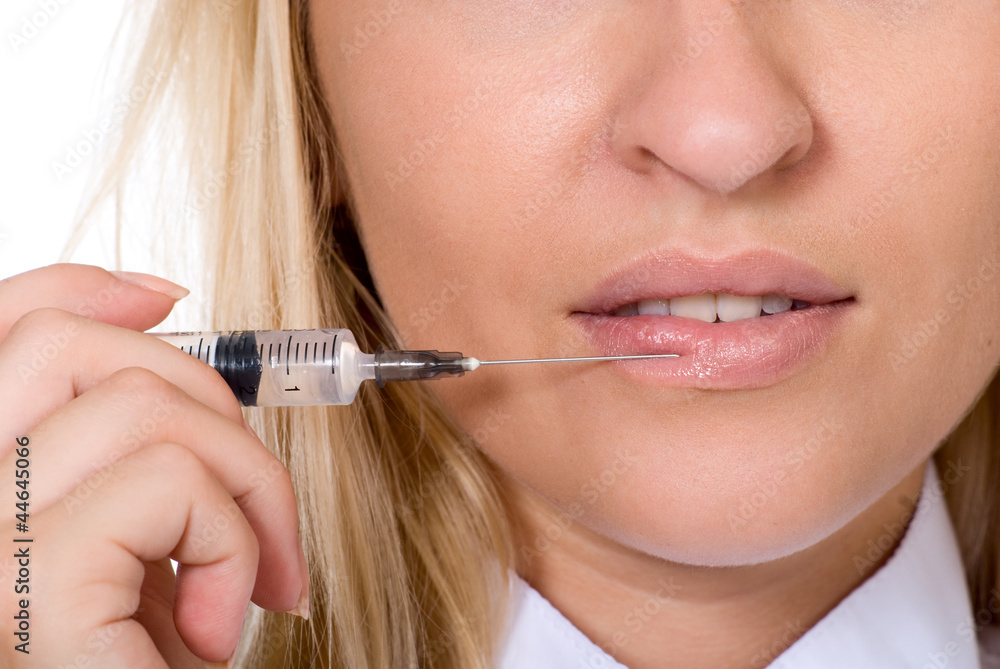 Beautiful woman recieving a injection in her lip Beautiful woman recieving a injection in her lip