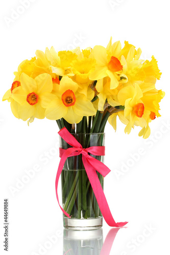 Fototapeta Naklejka Na Ścianę i Meble -  beautiful yellow daffodils in transparent vase with bow
