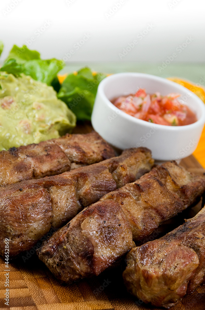 Ecuadorian food series: pork ribs with salad and pepper sauce