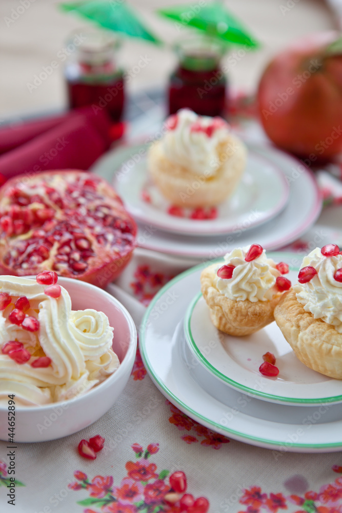 Little cakes with cream and pomegranate Little cakes with cream and pomegranate
