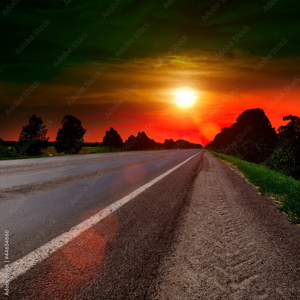 asphalt road at sunset