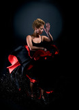 Portrait of beautiful young woman dancing flamenco studio shot